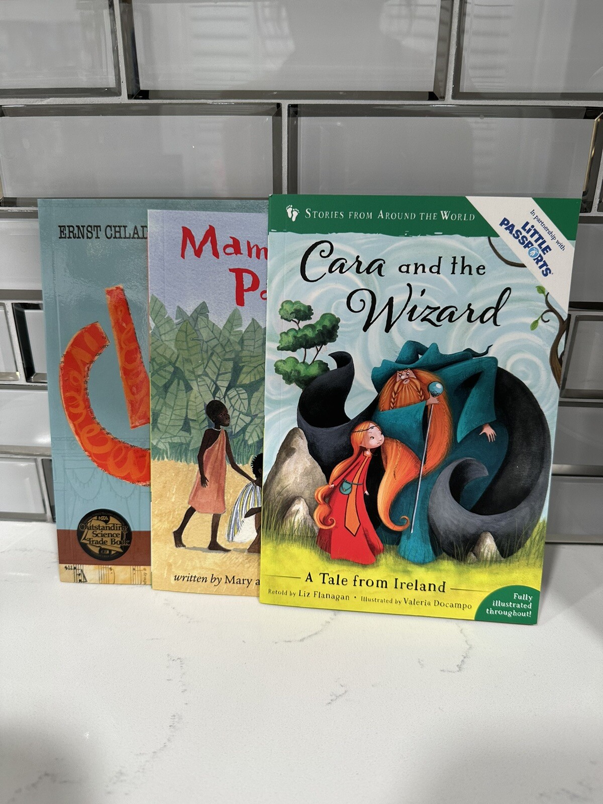 Little Passports Lot of 3 books: Cara and the Wizard,Mama Panya’s Pancakes,Clang